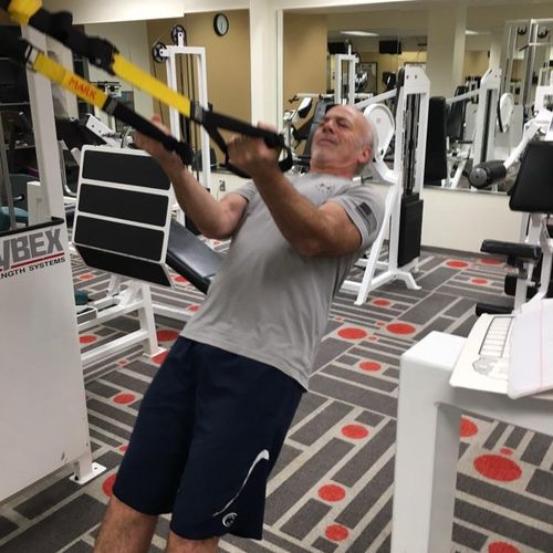 TRX biceps curl in client’s office gym