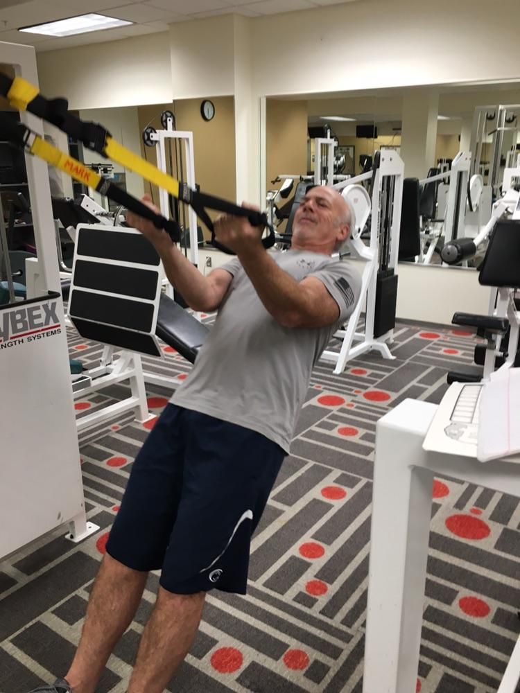 TRX biceps curl in client’s office gym