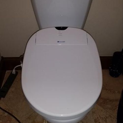 This toilet has a bidet seat that lights up and ha