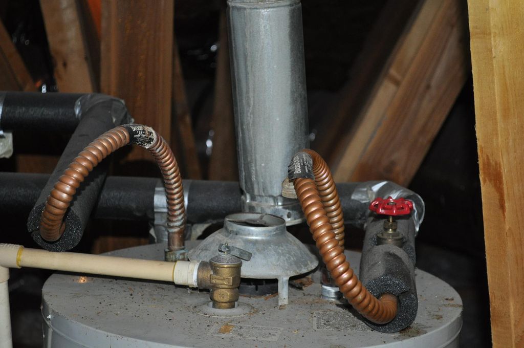 Exhaust flue disconnected discharging into attic (