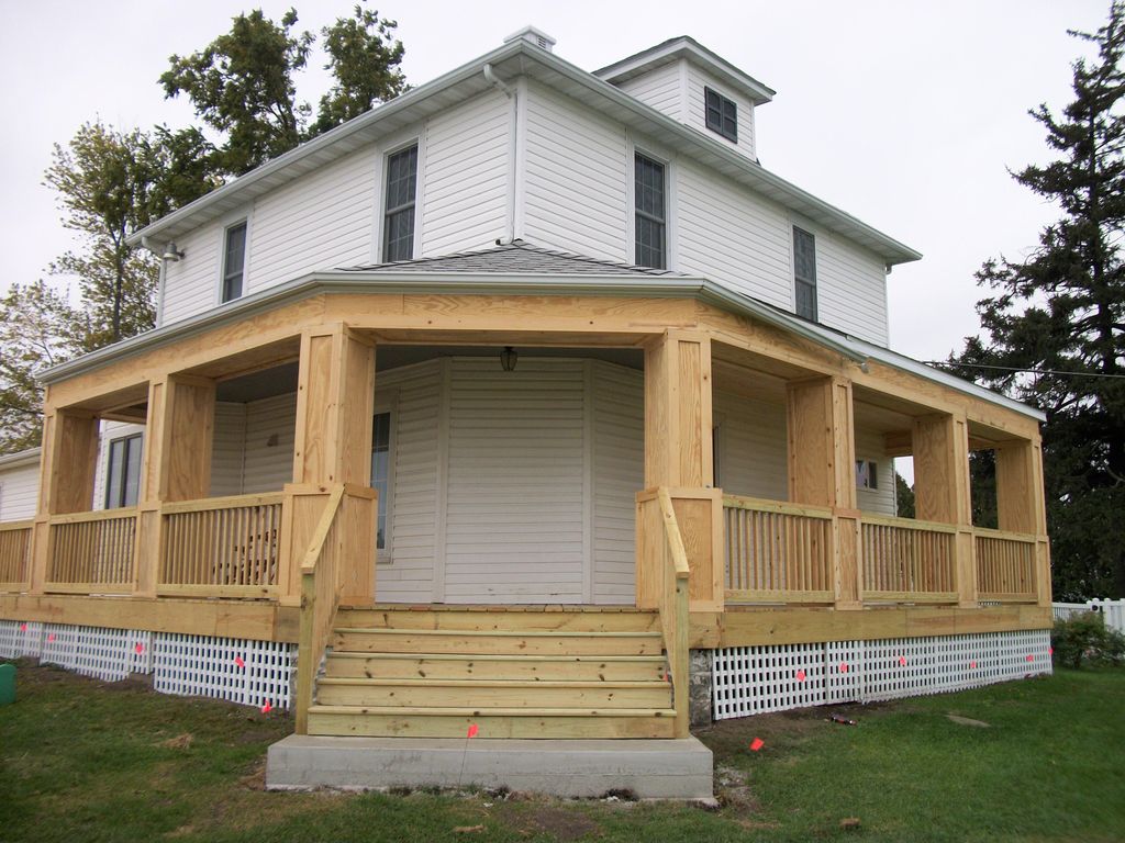 Treated wood wrap around deck with railings, spind
