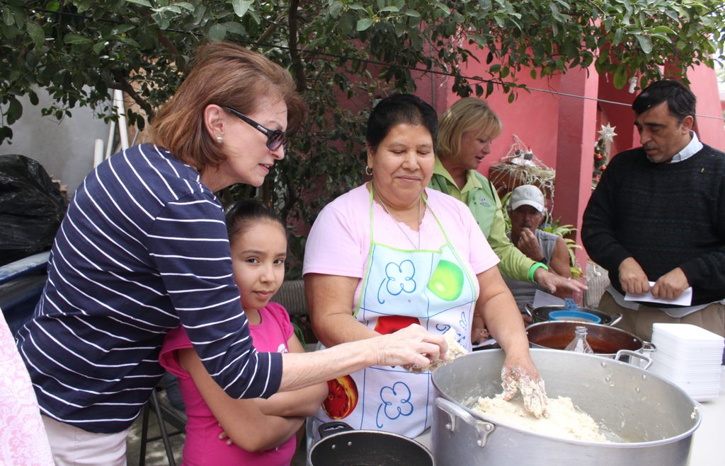 My aunt cooking two kinds of tamales from my Spani