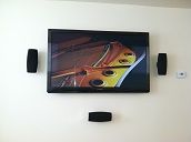 Mounted TV on a standard wall and the front speake