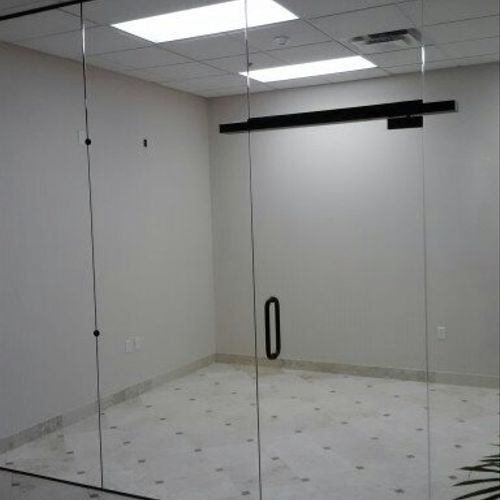 Glass wall with floating header and herculite door