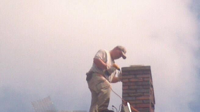 Lead Technician Robert Irvin putting on chimney ca