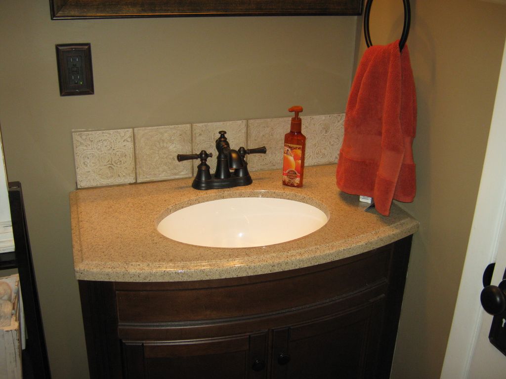 Vanity install with tile backsplash