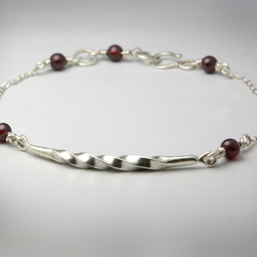 Hand forged sterling silver bracelet with garnet b