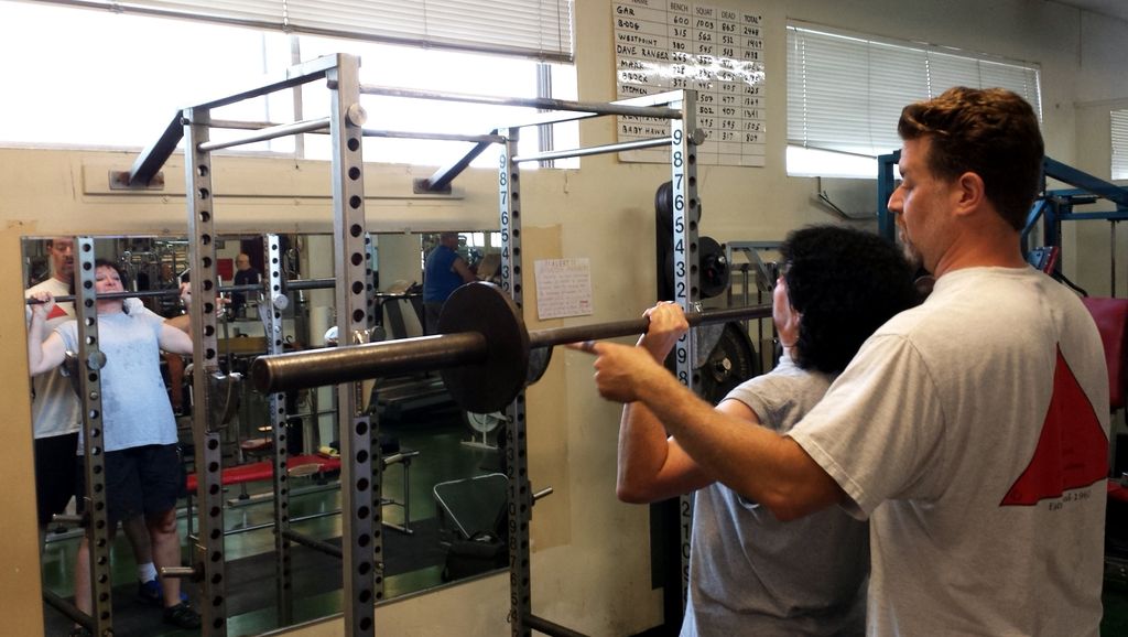 Spotting a client with her Over Head Press.