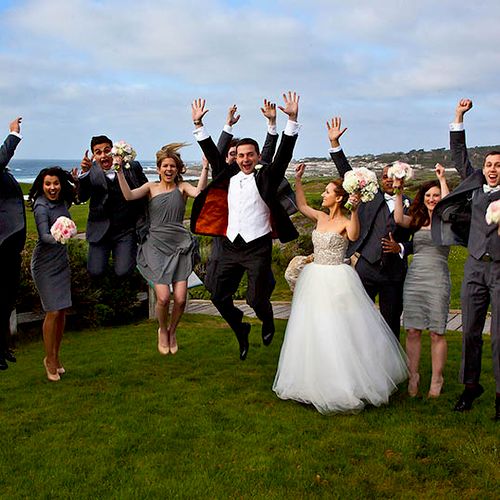 A bridal party enthusiastically enjoys the photo s