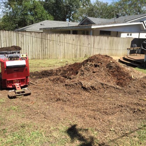 Removing excess mulch from a stump and leveling th