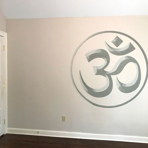 The symbol for "ohm" painted on the wall of a priv