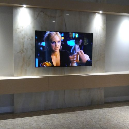 A 65" Sharp TV Mounted On An Articulating Arm Wall