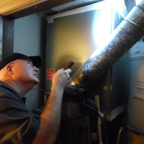 Inspecting the inside A/C unit.