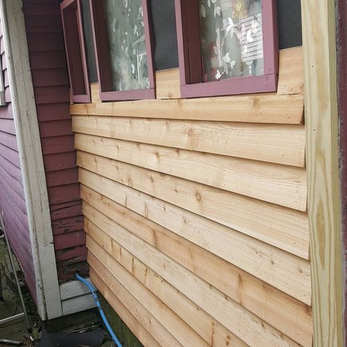 a in progress of a cedar siding completed and pain