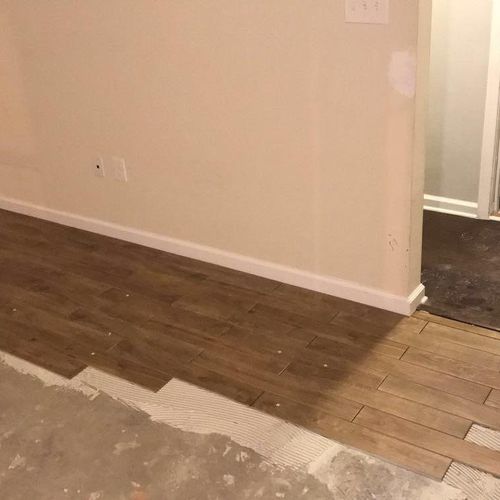 Installing imitation wood plank tile flooring