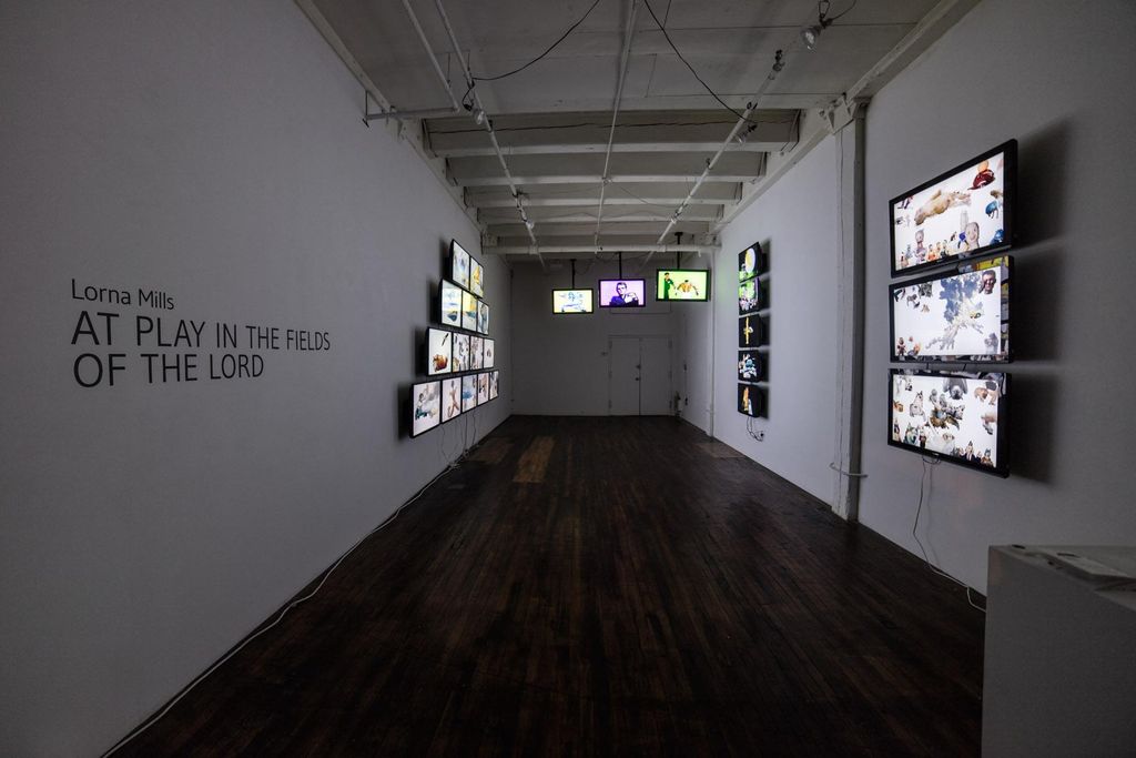 A dark room with several TV screens. This was shot