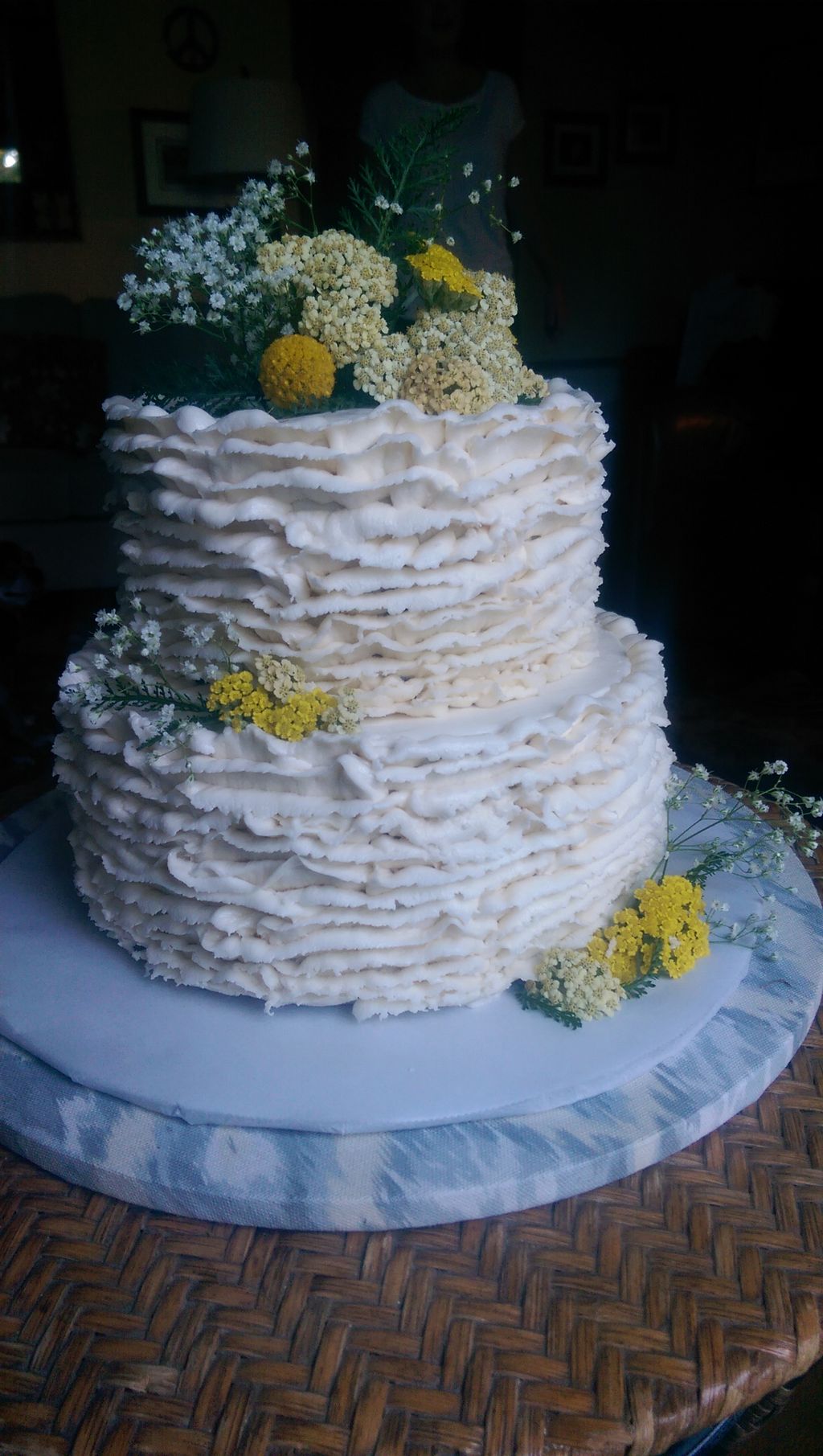 Two tiered buttercream cake with a trendy ruffle f