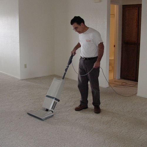 Vacuuming with a CRI approved vacuum.