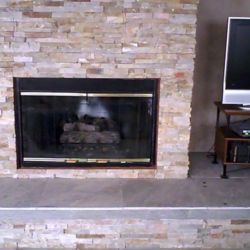 Fireplace covered in Natural ledger stone with a s