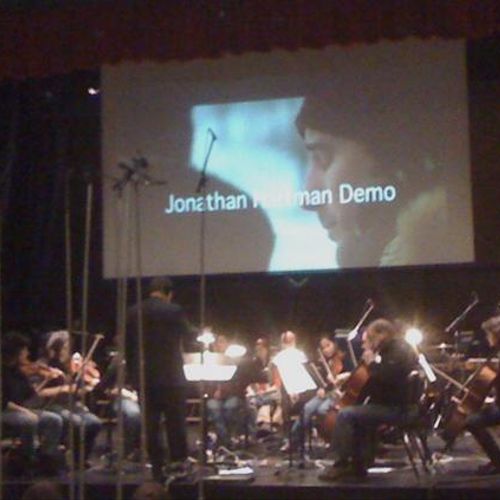 Jonathan Hartman conducting a chamber ensemble in 