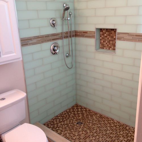 All glass tile master bathroom with metal tile tri