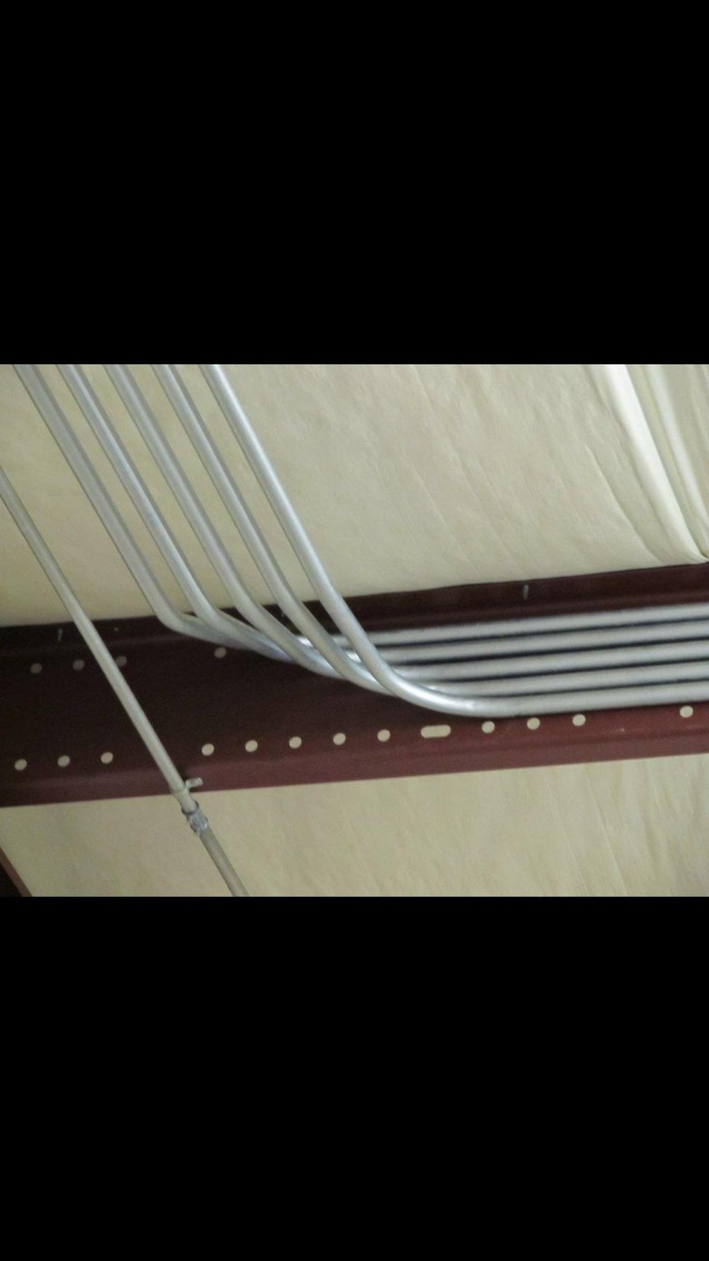 Small rack of conduit feeding CNC machines. 