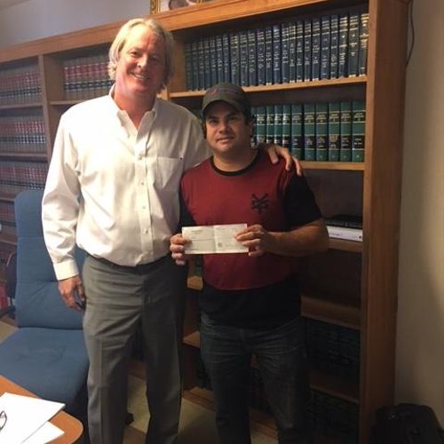 Juan G. receiving his settlement check July 2017
A