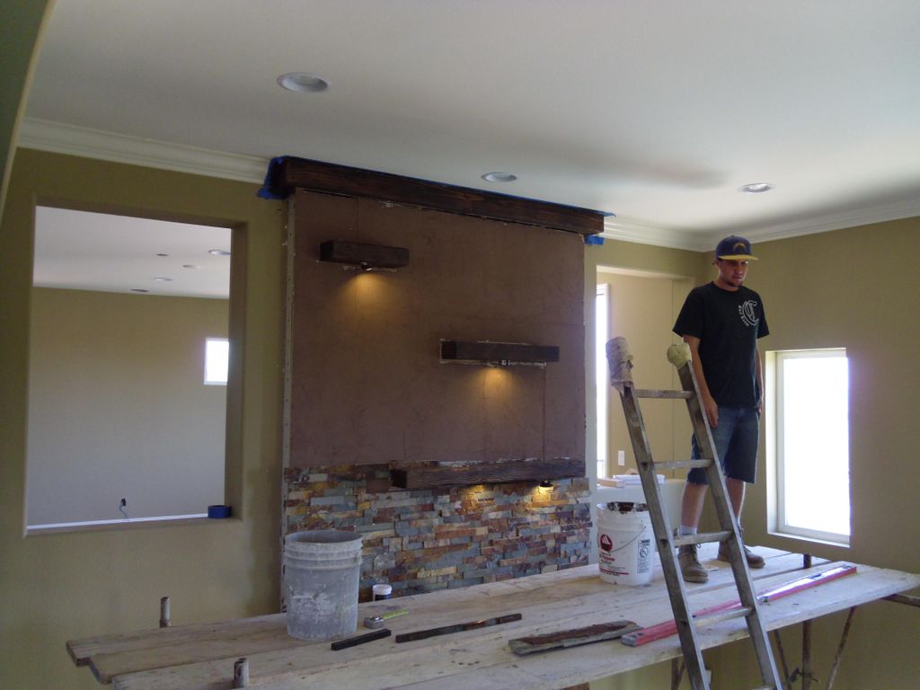 Stone fireplace with ledges and lighting