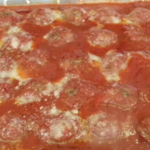 Tray of homemade meatballs and sauce.