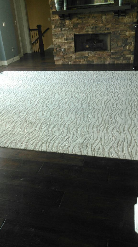 The color of wood and pattern of carpet compliment
