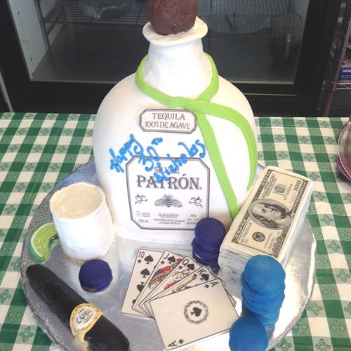 3D sculpture of a Patron bottle. Cake is covered i