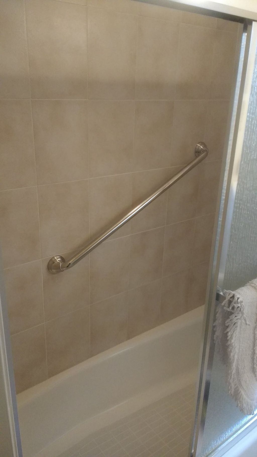 Shower grab bar installed in tile.