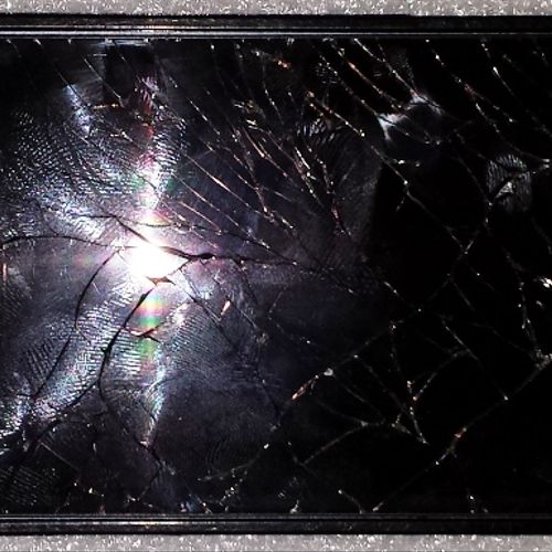 iPhone 5 with shattered glass and broken LCD. July