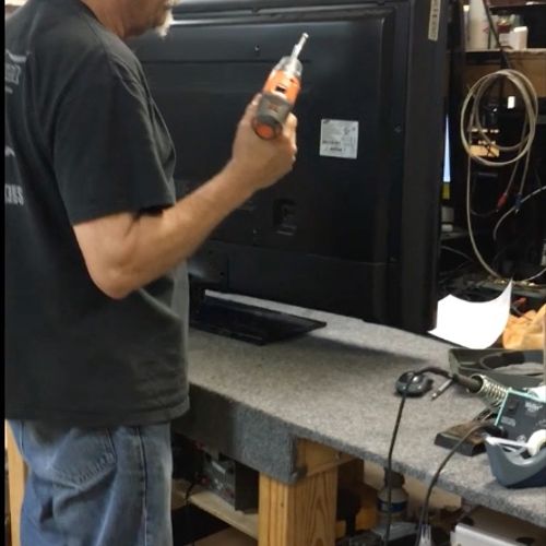 Tech working on a TV repair