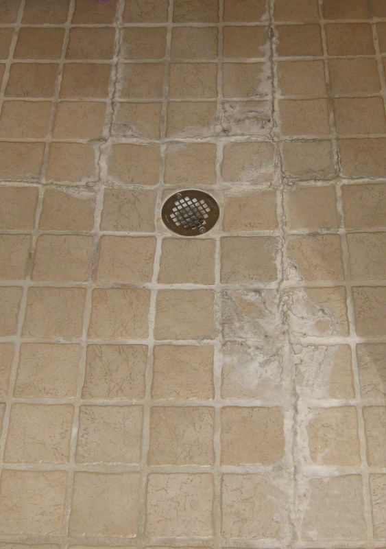 Shower floor mineral deposit build up, before