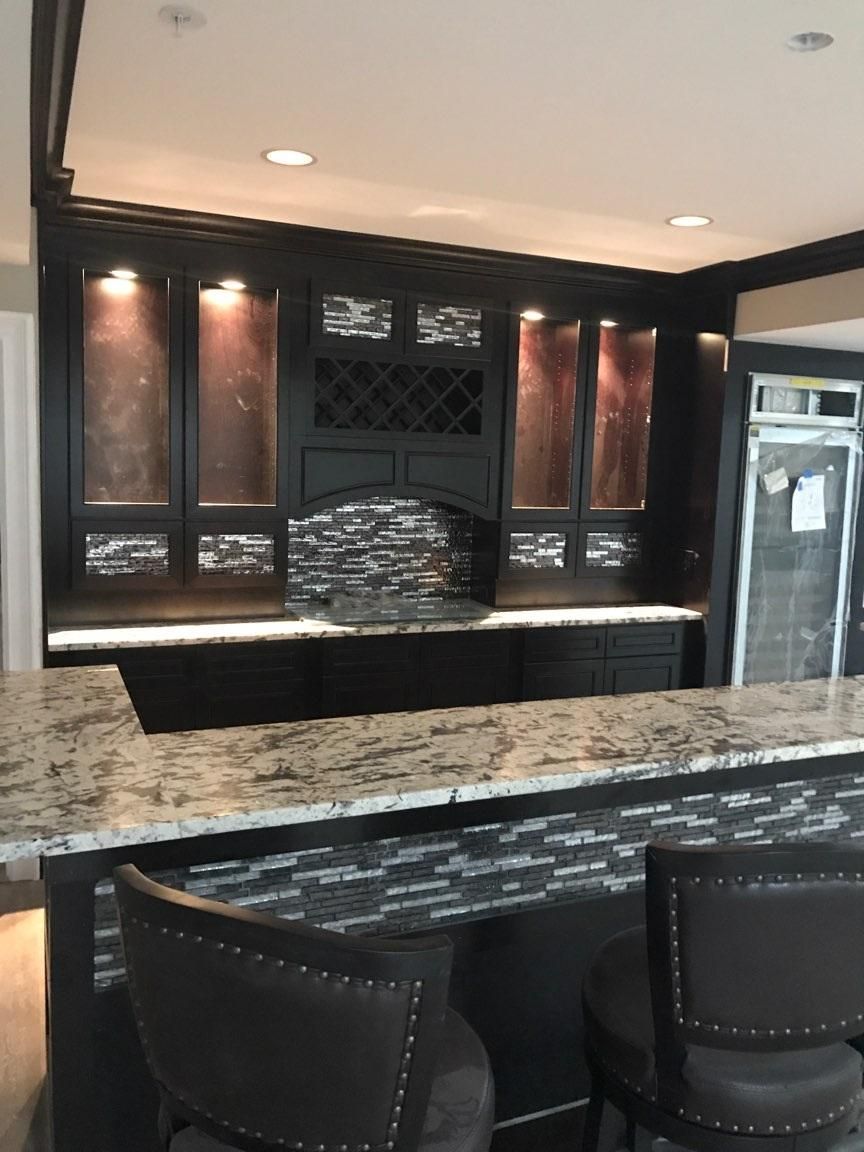 Glass tile in this bar sets off the espresso cabin