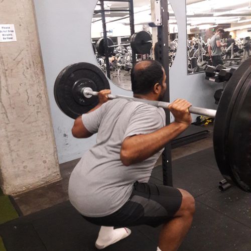teaching a client how to squat properly 