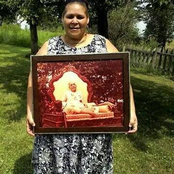 Holding a picture of HDG Prabhupada