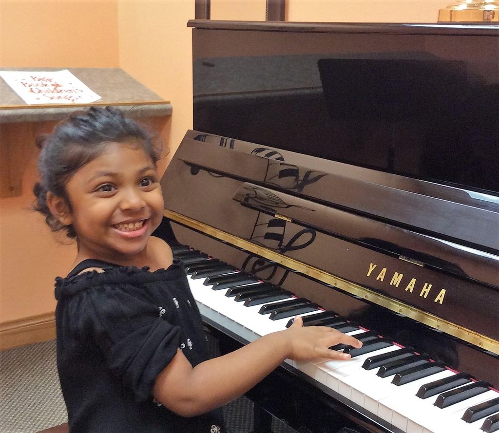 Gia loving her piano lesson