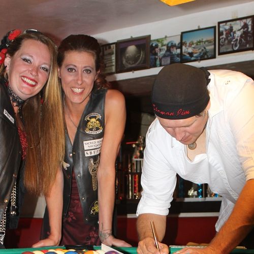 Signing wed cert on pool table w/ bride & her b. m