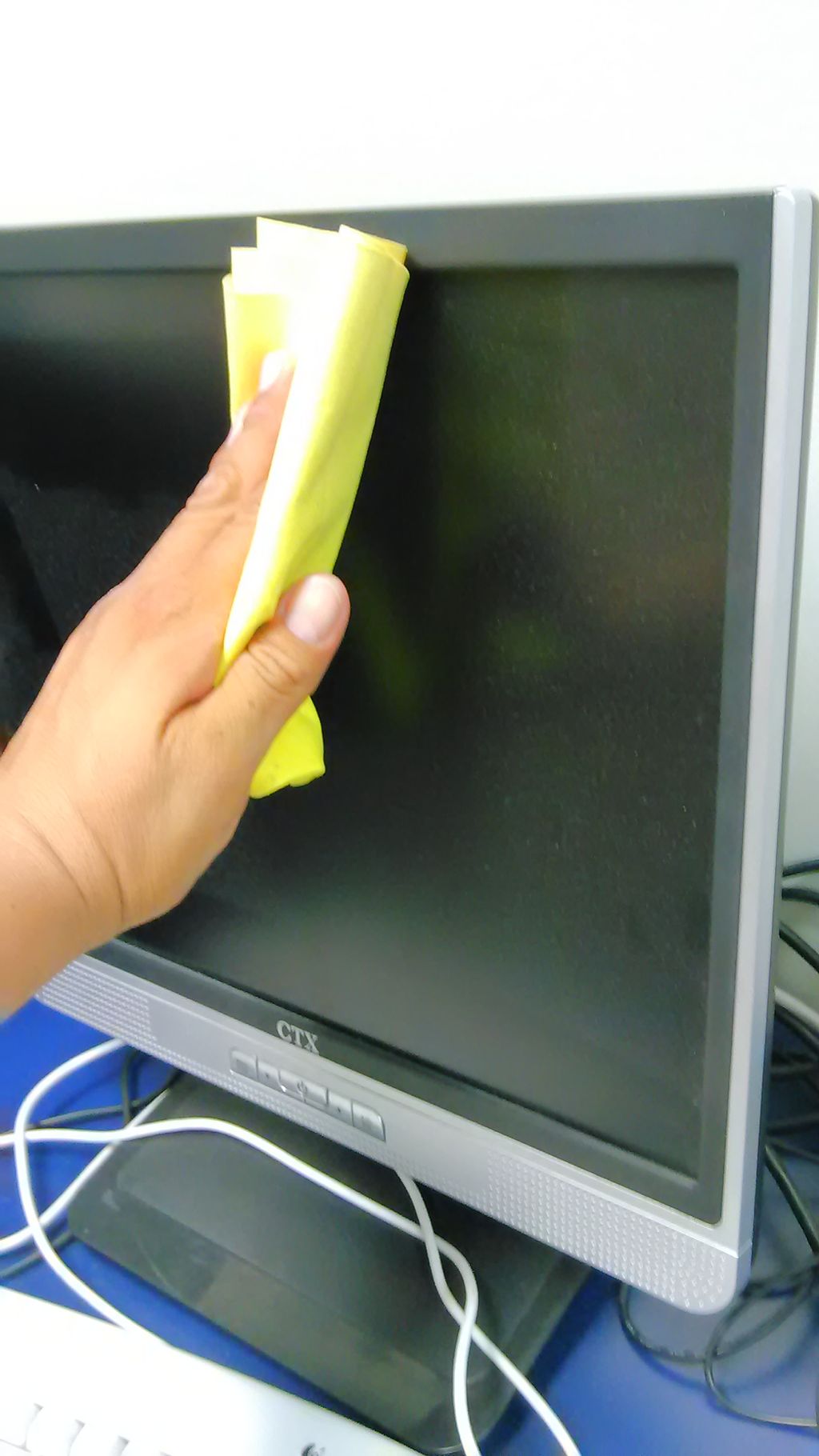 Wiping dust from computer screen