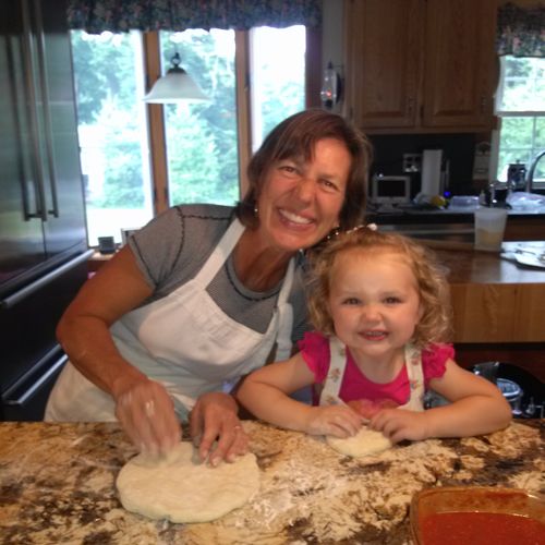 Elizabeth teaching Gabby to make Italian pizza for