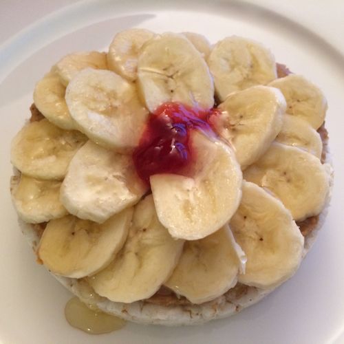 Rice cake, almond butter, banana, and dollop of ja