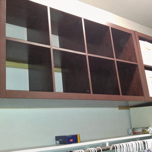Ikea shelving units mounted to wall in closet