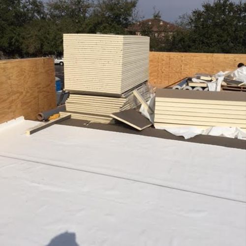 M & M Roofing Installing ISO Board insulation unde