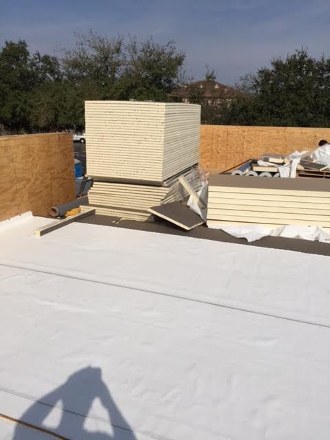 M & M Roofing Installing ISO Board insulation unde