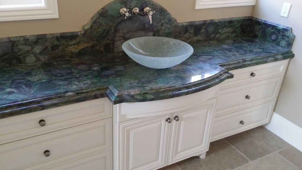 Bathroom granite counter with glass sink.