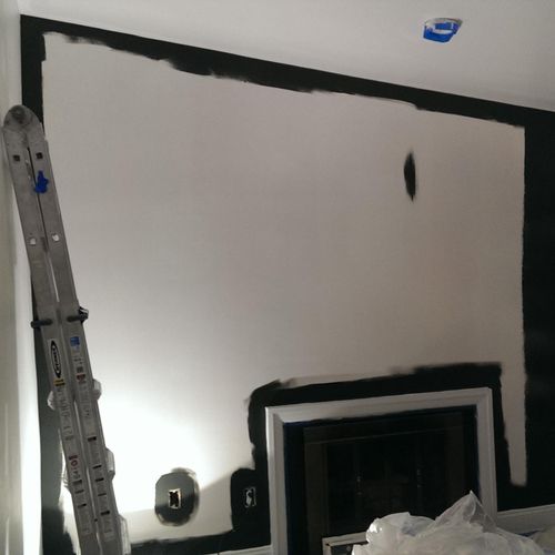 Cutting in the paint on wall and around fireplace.
