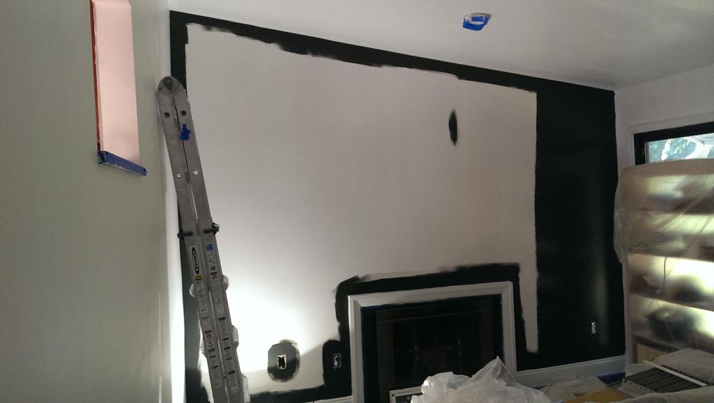 Cutting in the paint on wall and around fireplace.