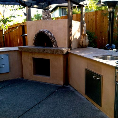 BBQ Grill and Oven with sink and counter.